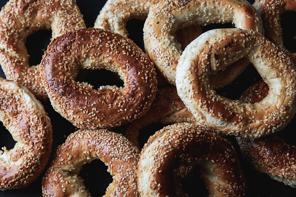 several bagels with sesame seeds piled atop one another