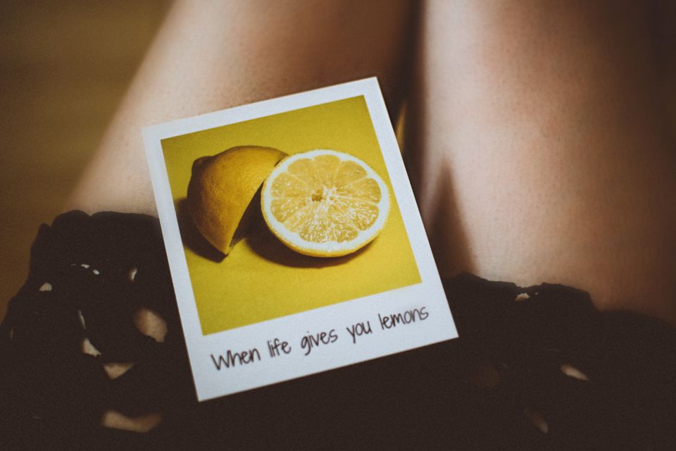 a polaroid of a sliced lemon with the caption "when life gives you lemons"
