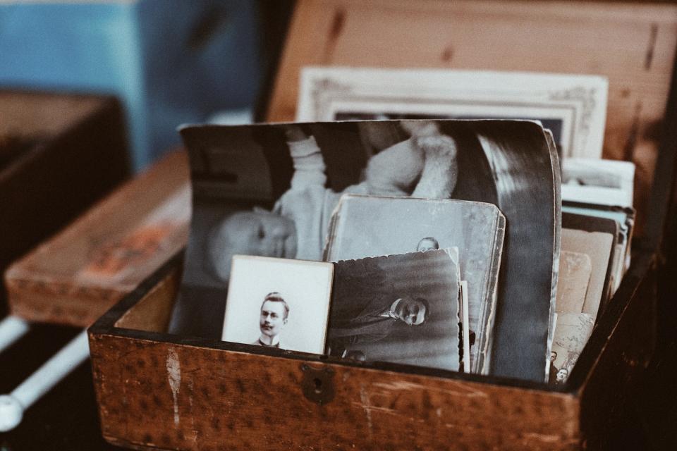 vintage family photos sit in a wooden box