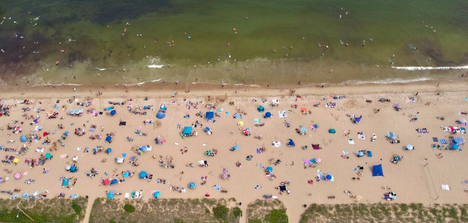 an aerial image of several people on the beach