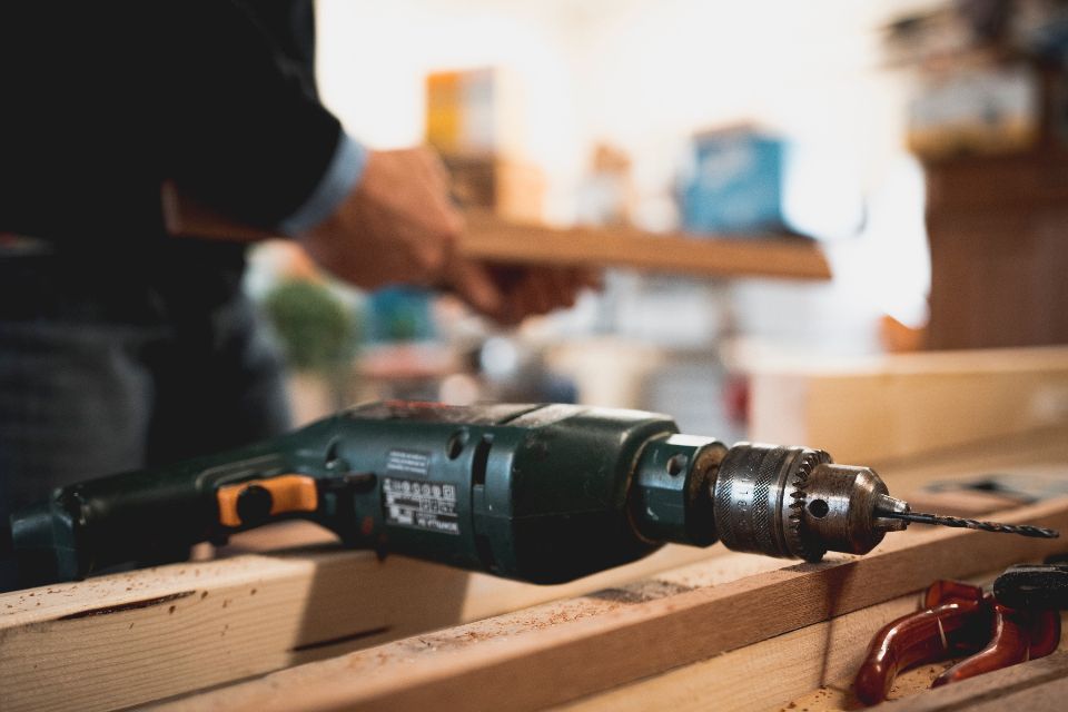 macro image of a drill with a craftsman in the background
