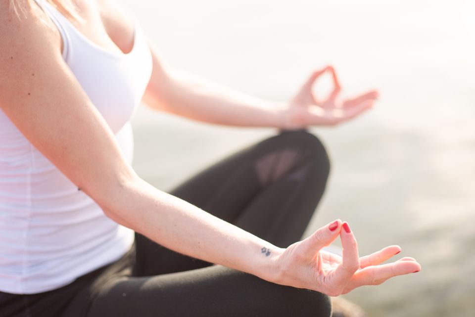 photograph of a woman in a yoga pose meditating