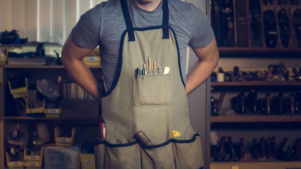 image of a craftsman putting on their apron